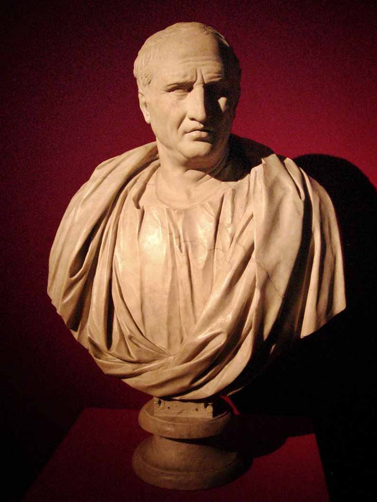 White marble bust of Cicero against a red background.